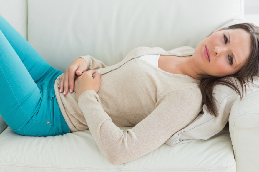 anxious and sick woman lying on a sofa