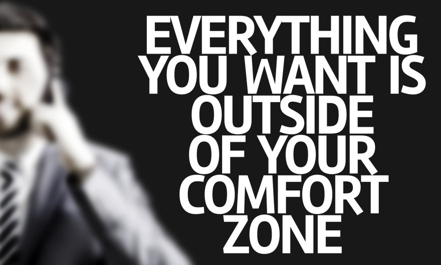 Business man with the text Everything You Want is OUtsie of Your Comfort Zone