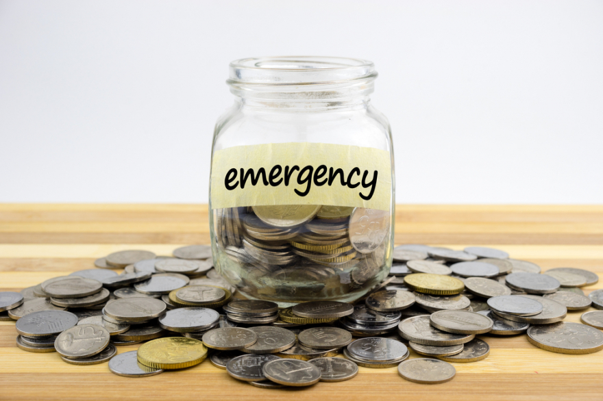 coins in a glass container on a wooden surface