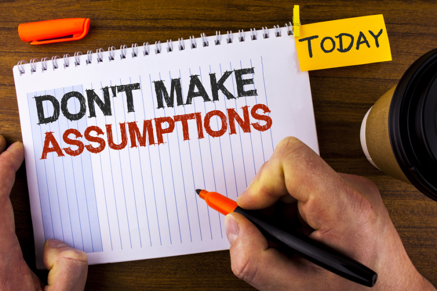 don't make assumptions written on note pad