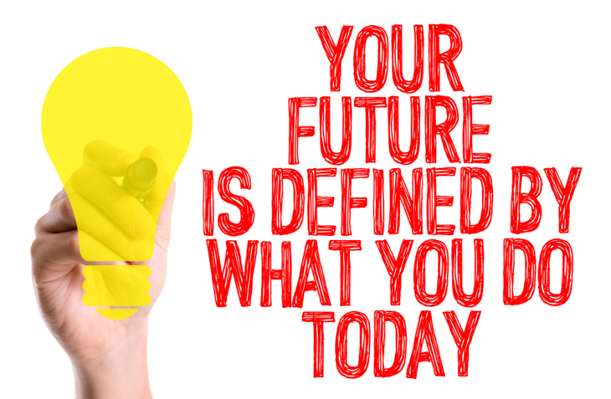 Hand with marker writing your future is defined by what you do today