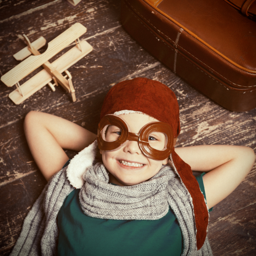 little boy in pilot headgear and eyewear