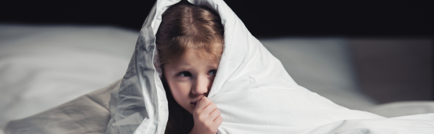 Panoramic shot of scared child hiding under blanket isolated