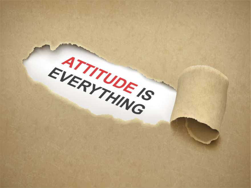 Paper torn to reveal phrase attitude is everything