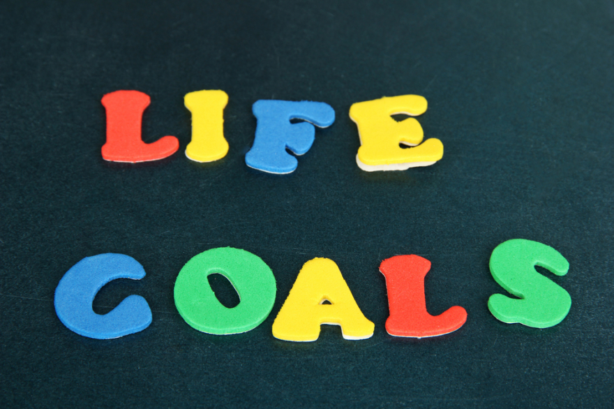 Phrase Life Goals written on blackboard in bright letters close up