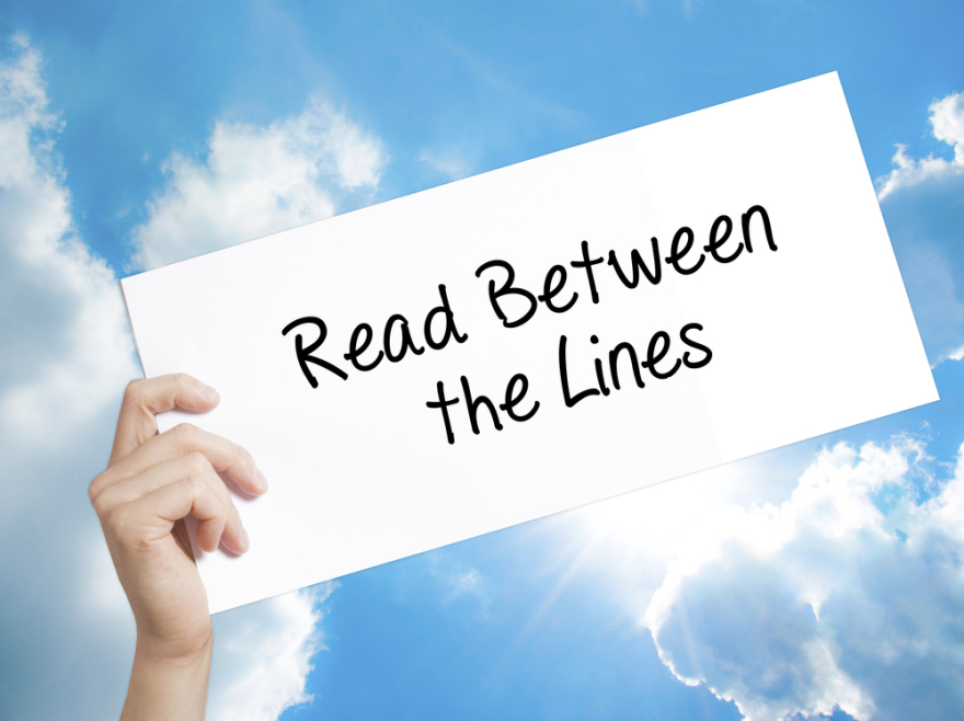 Read Between the Lines Sign on white paper