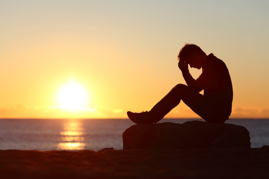 Sad man silhouette on beach