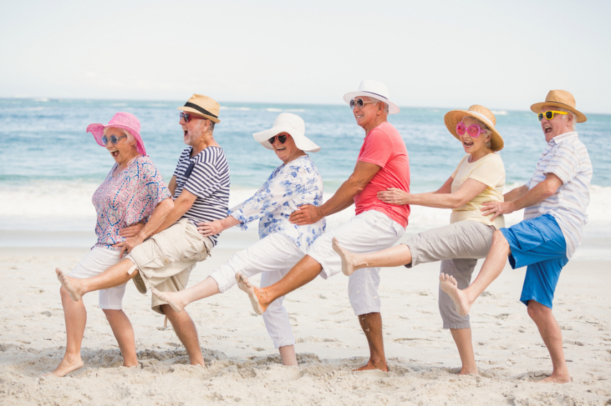 Senior friends dancing on the beach