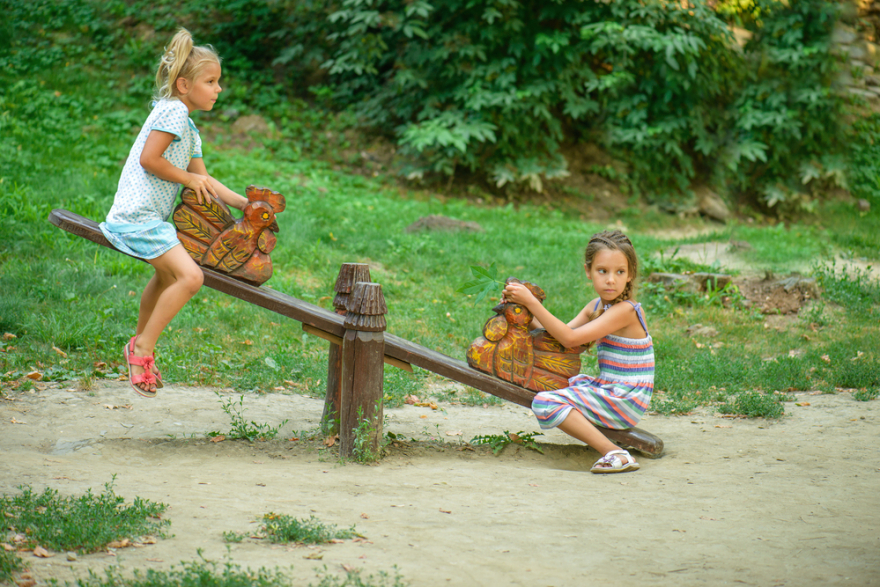 two sisters on a seesaw