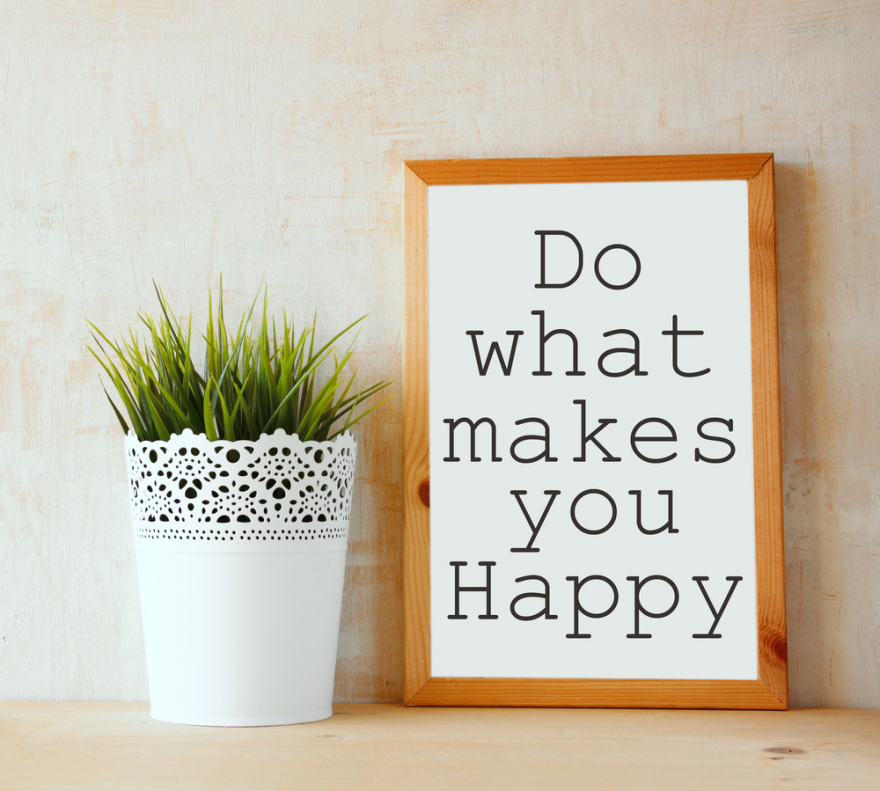 white drawing board with do what makes you happy written on it