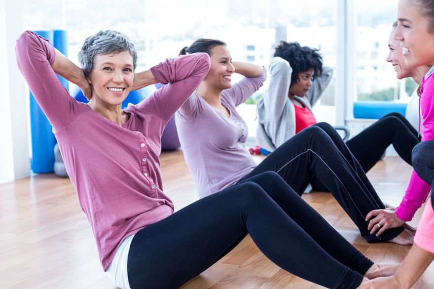 woman doing sit ups with friends