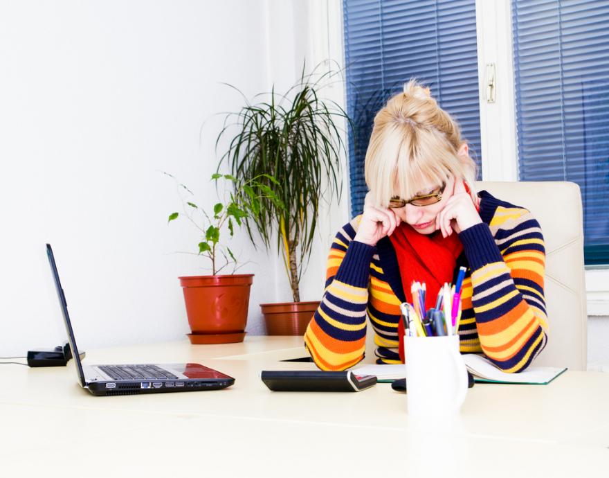 Young business woman sitting at a work desk