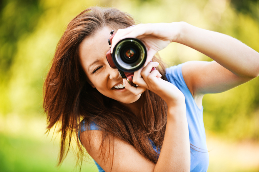 young smiling woman taking photo